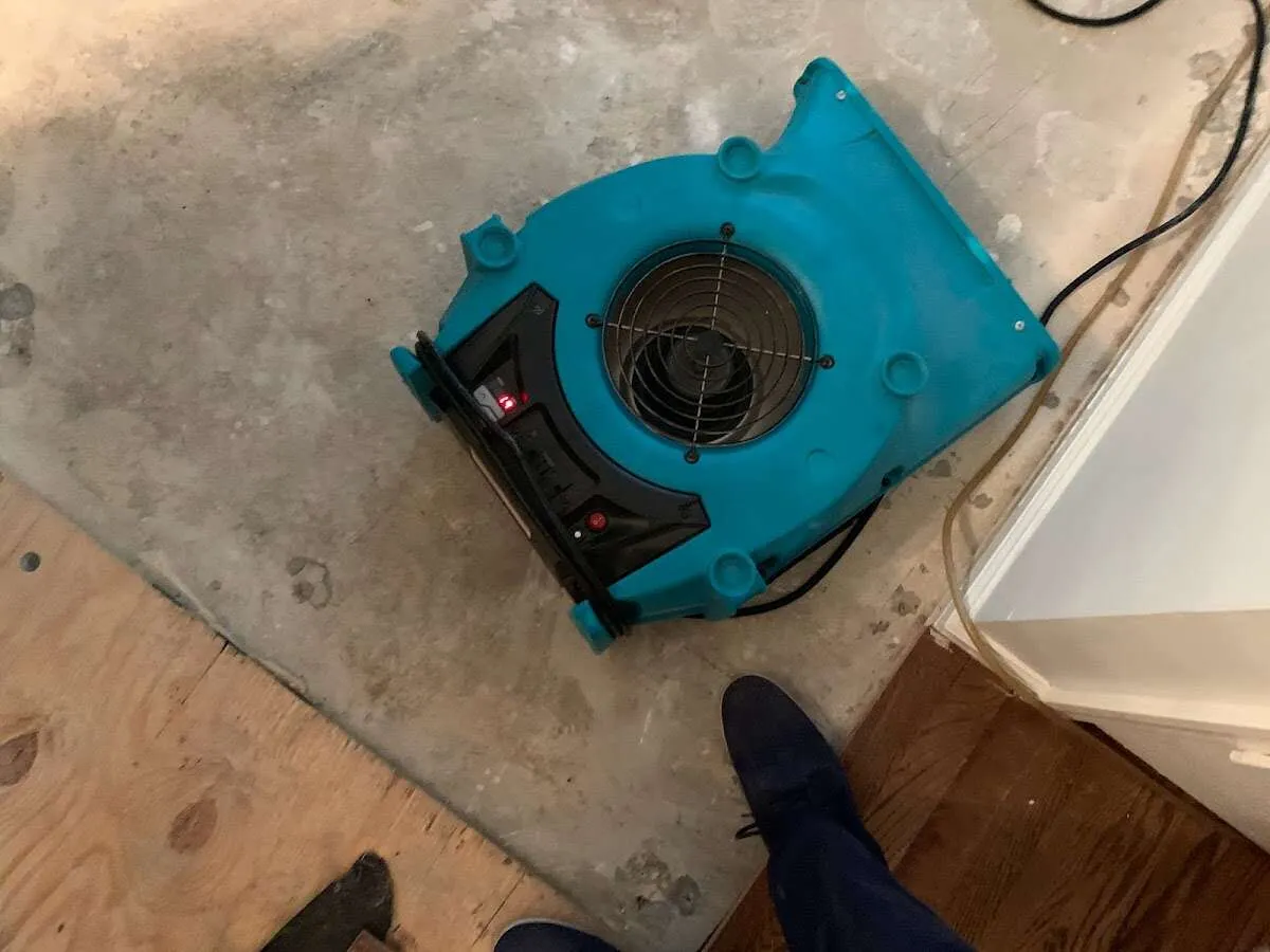 Air mover drying subfloor during Leak Detection & Repair in Nashua